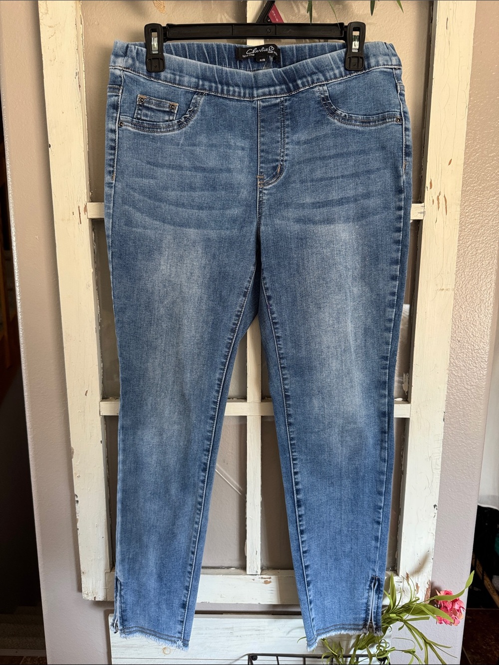 Charlie brand Light Wash Blue Stretch Jeggings with raw hem/zipper detail.